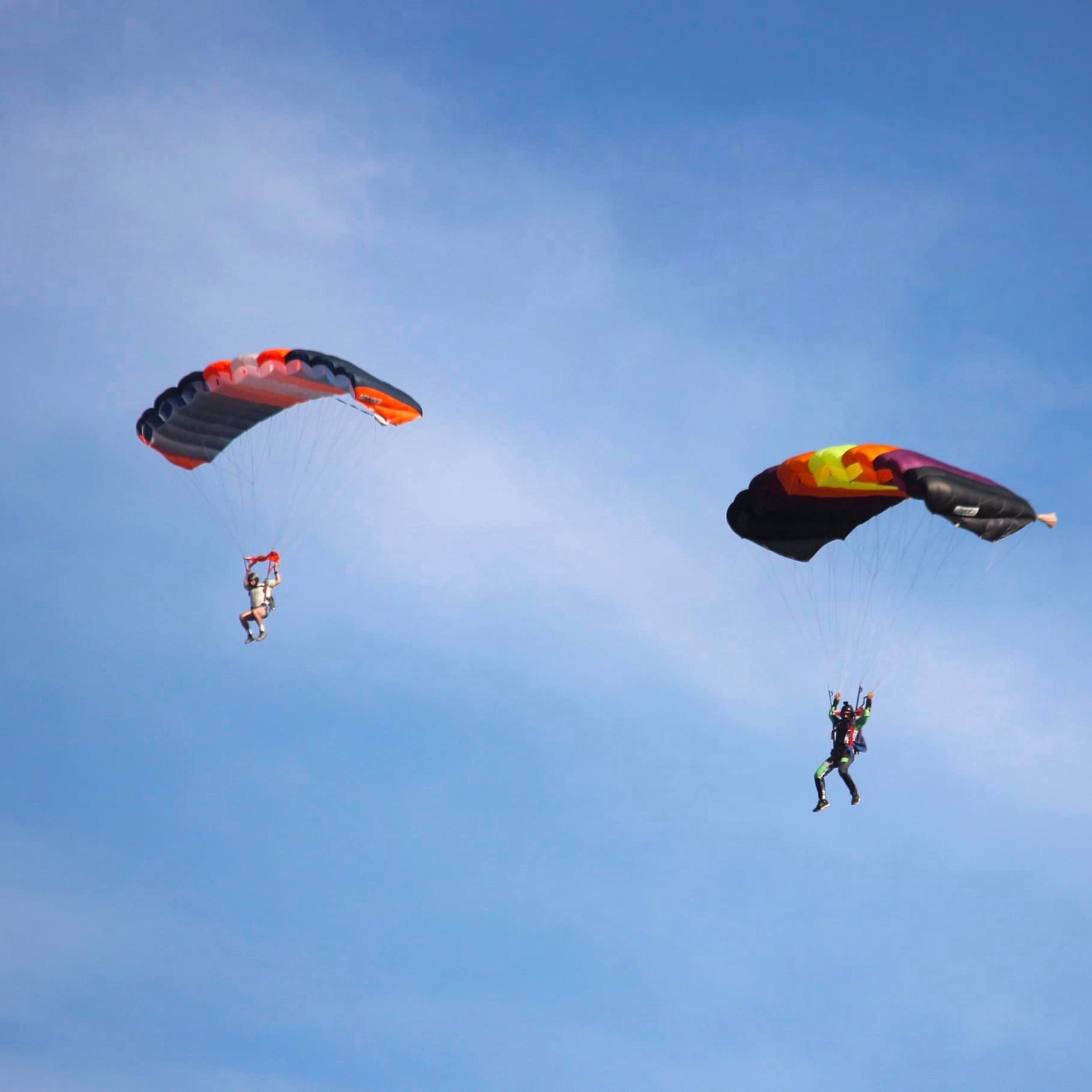 tandem skydiver exiting aircraft at altitude